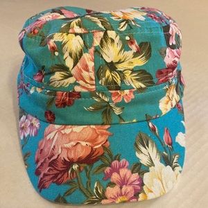 Cute flat top military style hat with flower design on turquoise